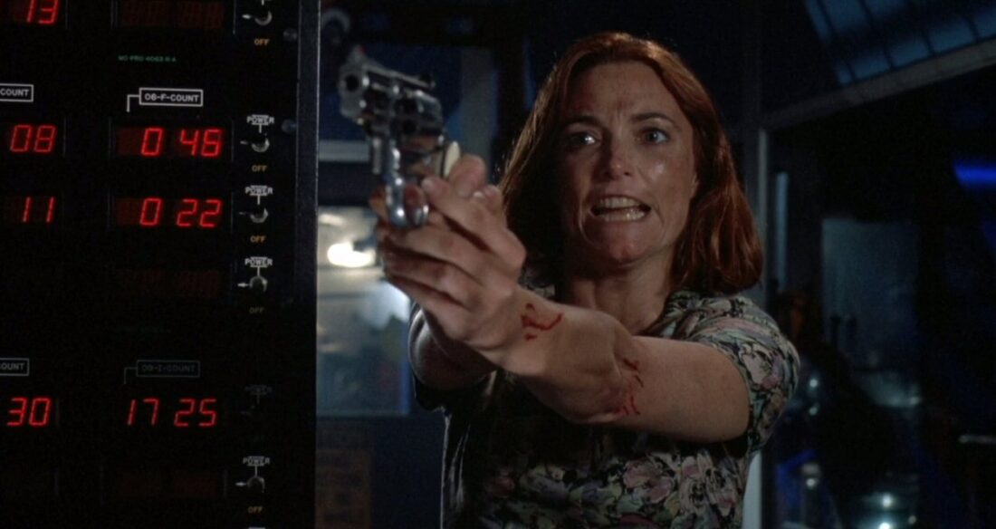 Karen Allen, dirty and holding a gun on the killer in Ghost in the Machine