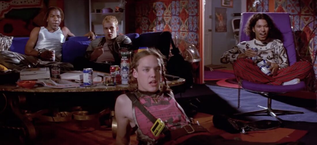 The hacker crew waiting in front of the TV to watch Hack the Planet in Hackers
