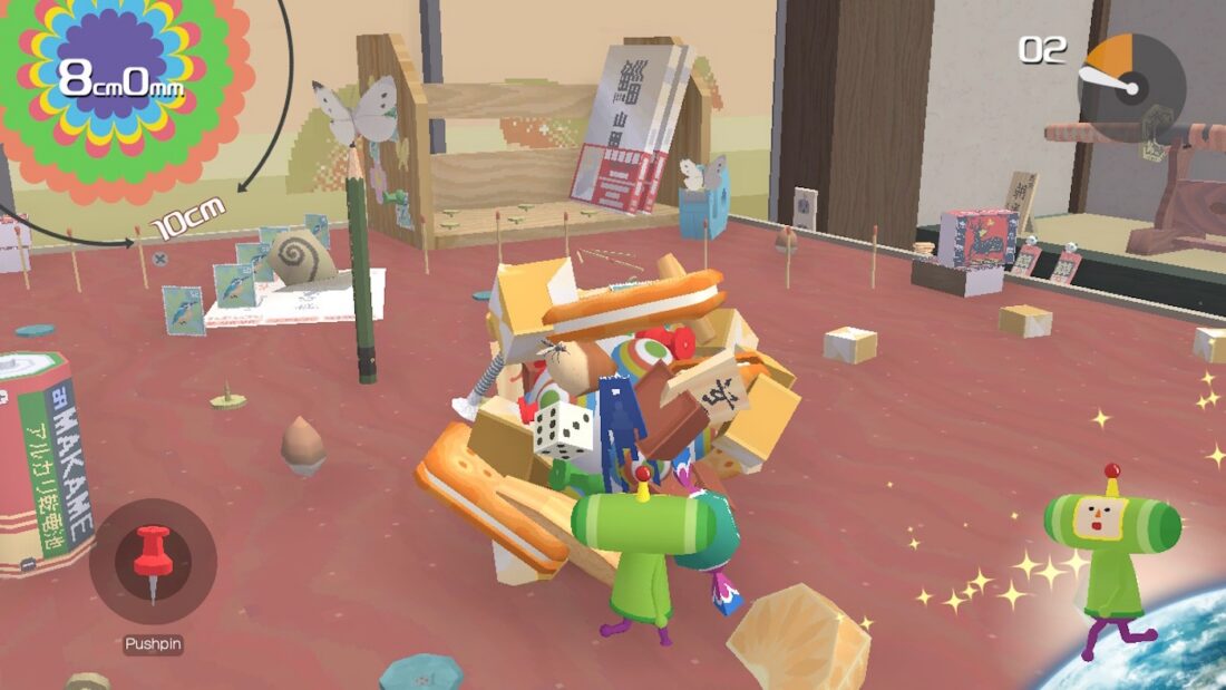 Screenshot from the video game Katamari Damacy Reroll: the Prince rolls a katamari ball across a table