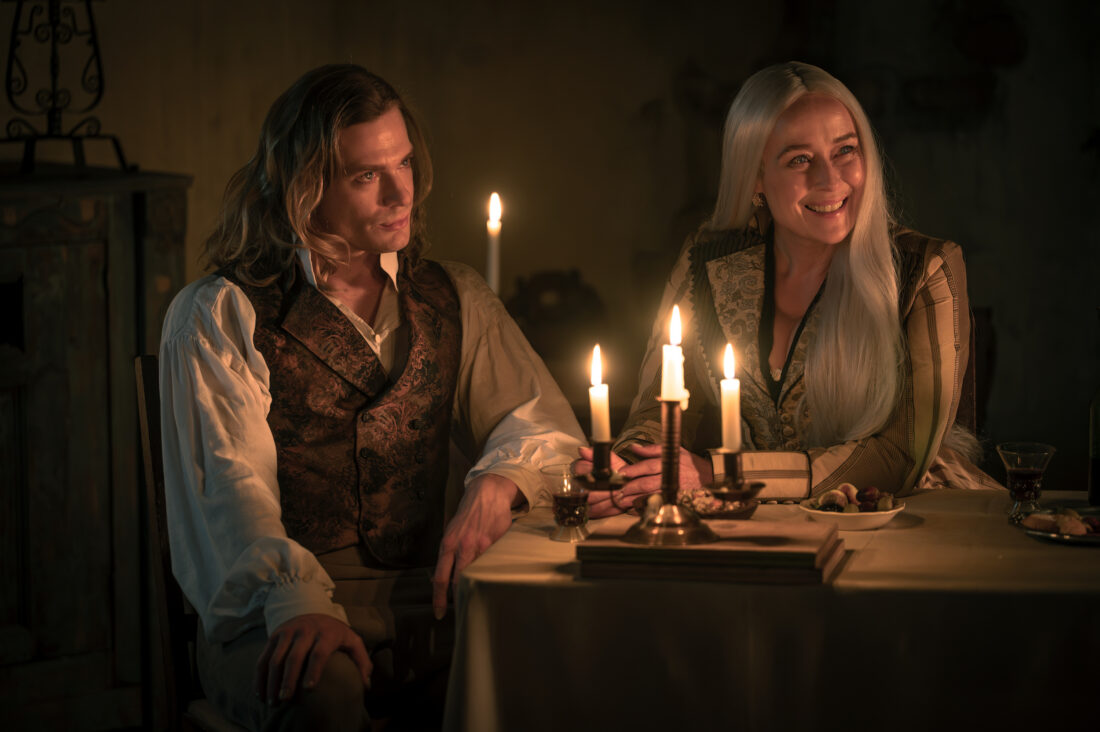Sam Reid as Lestat De Lioncourt and Jennifer Ehle as Gabriella sitting at a table in Italy in the 19th century - Anne Rice's The Vampire Lestat _ Episode 04