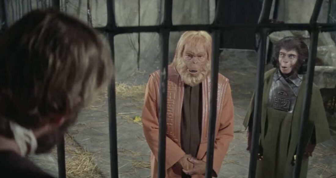 Dr. Zira pointing out Taylor in his cage to Dr. Zaius in Planet of the Apes