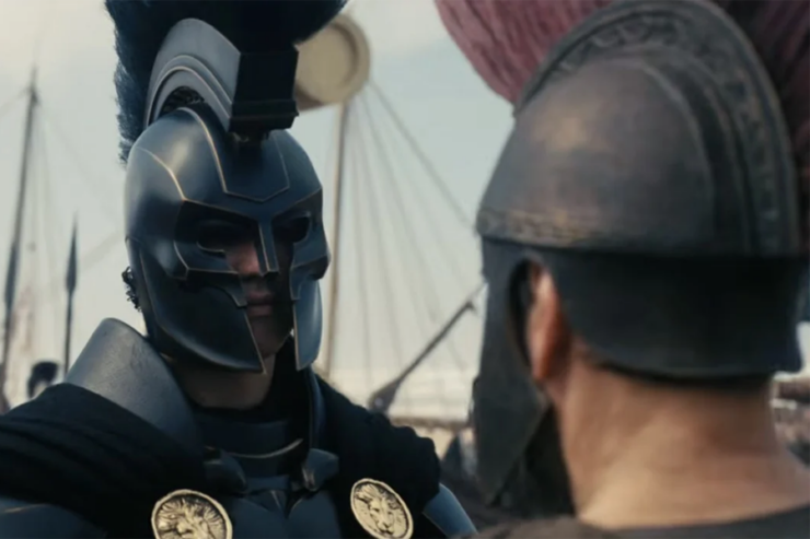 A soldier in black armor and with lion emblems confronts Odysseus (Matt Damon) in The Odyssey (2026)