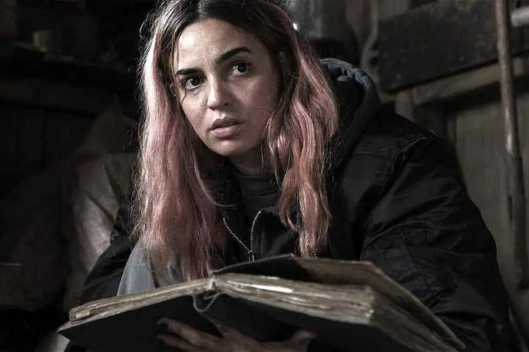 Image from Evil Dead Burn: Alice (Souheila Yacoub) with an open book