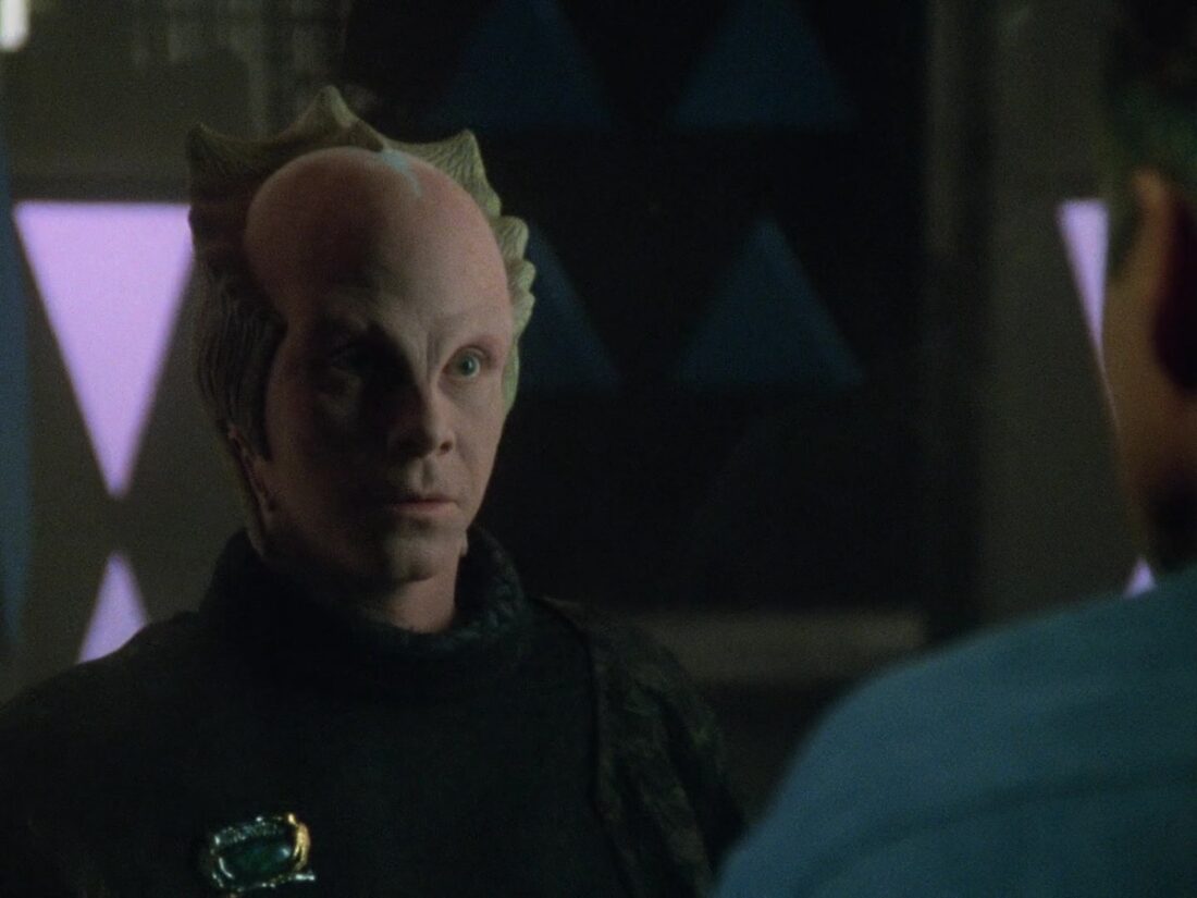 Screenshot from Babylon 5 "Objects at Rest": Lennier looks at Sheridan through an airlock