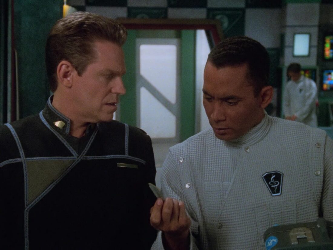 Screenshot from Babylon 5 "Objects in Motion": Allan and Dr Franklin examine a comm link